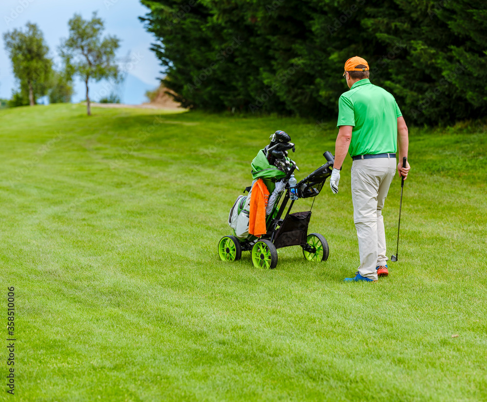 Golf cart with bag and golf clubs on a golf course. Golf cart with bag and golf clubs on a golf course.