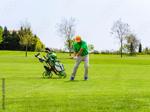 Close up Golfer is driving golf ball to green course