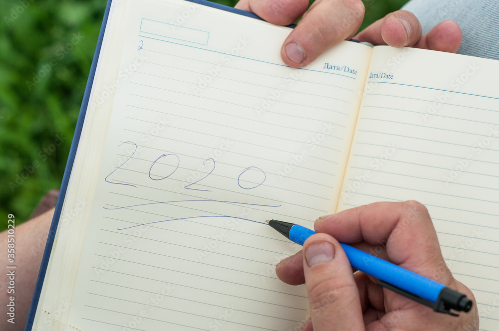 Senior old woman writing down letters on a piece of paper, recording a journal or diary entry or writing a 202 Senior old woman writing down letters on a piece of paper, recording a journal or diary entry or writing a 202