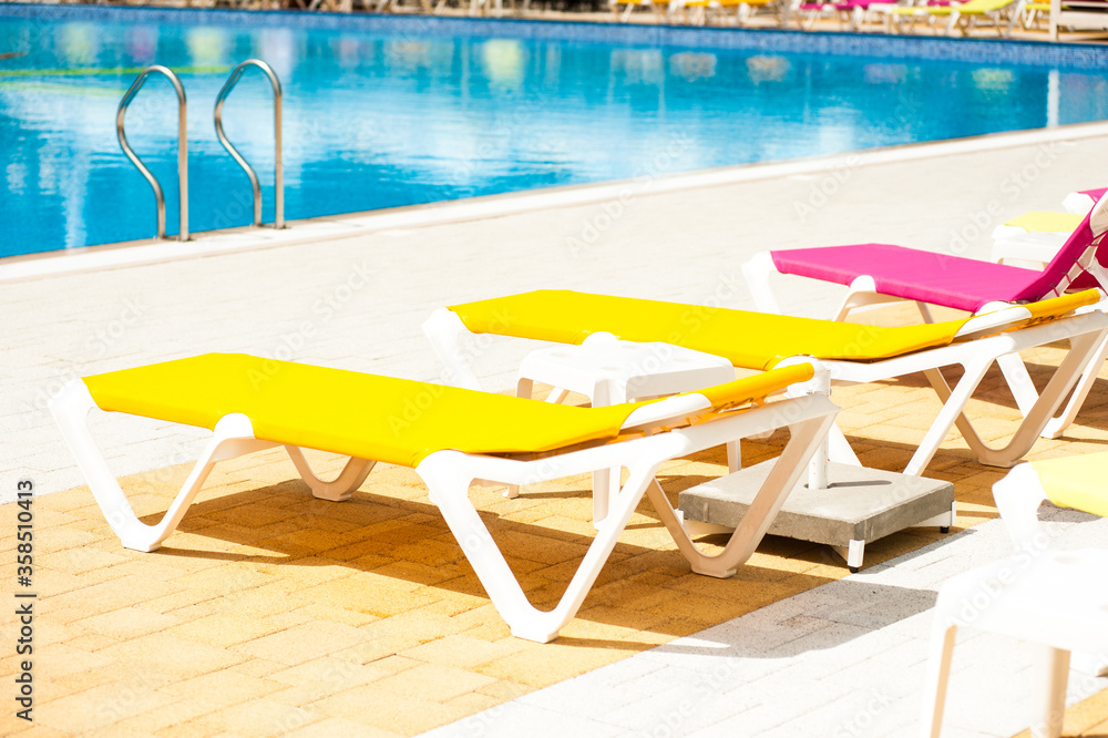 Fototapeta premium Sun loungers for sunbathing by the outdoor pool