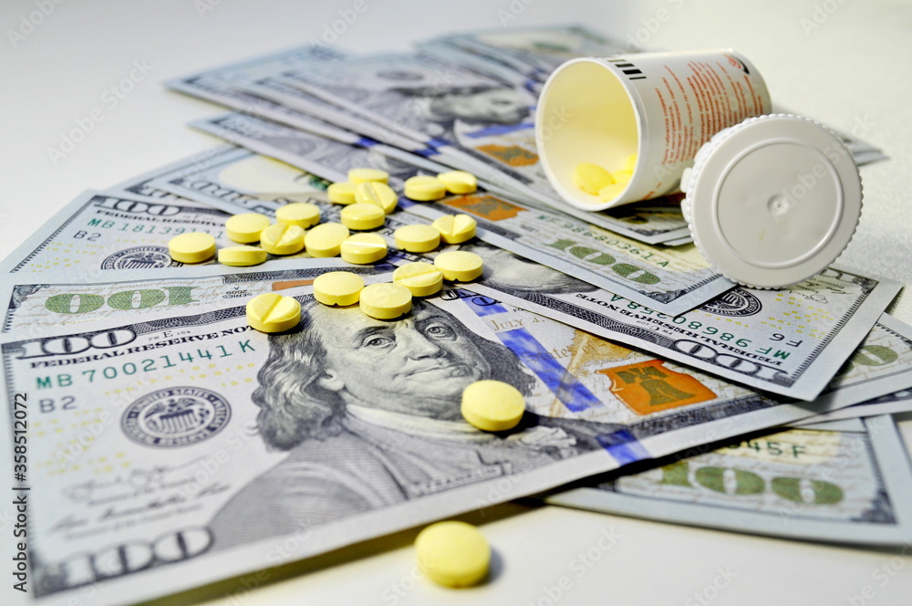 Composition consisting of money and pills. Money. Tablets. Medication. Composition consisting of money and pills. Money. Tablets. Medication.