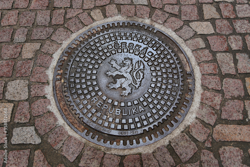  Street manhole cover on the paving stones in Prague, Czech Republic