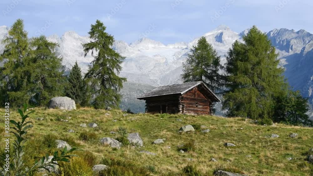 Mountain hut with wooden walls and panoramic view of the Adamello Glacier as a backdrop in summer - Real time
Mountain hut with wooden walls and panoramic view of the Adamello Glacier as a backdrop in summer - Real time