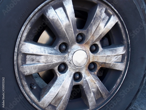 Closeup - dirty car wheels. Aluminum wheels have a lot of dust or black soot on the wheel rim caused by worn brake pads. Selective focus
