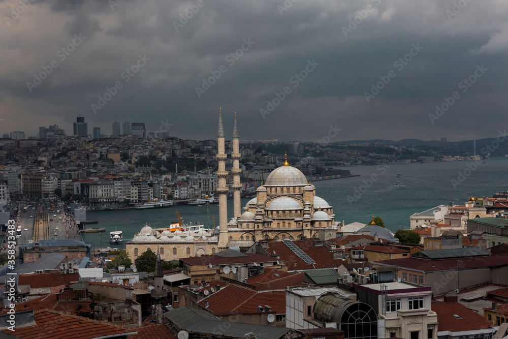 Spotlight over the New Mosque and skyline of Istanbul, Turkey