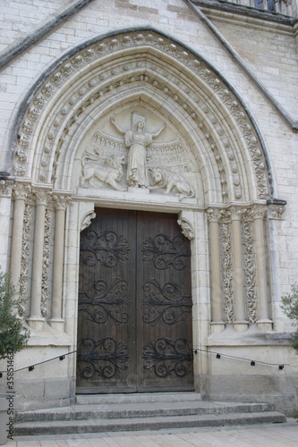 Decorated door of a French church welcoming visitors and believers © Doroteja_CRO