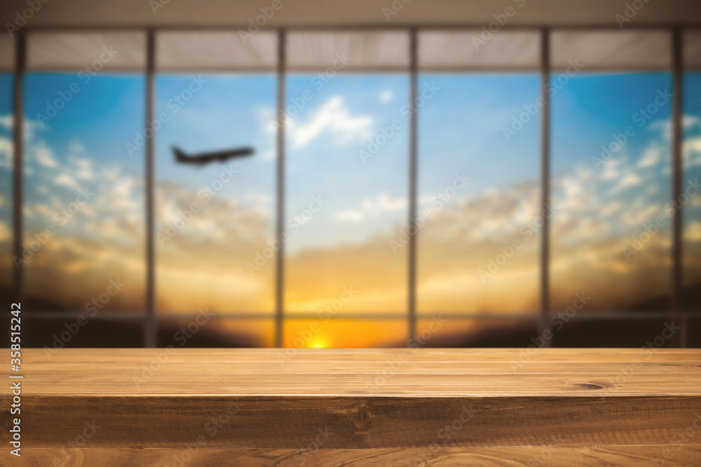 Fototapeta premium Empty wooden table space platform and Airport background for product display montage.