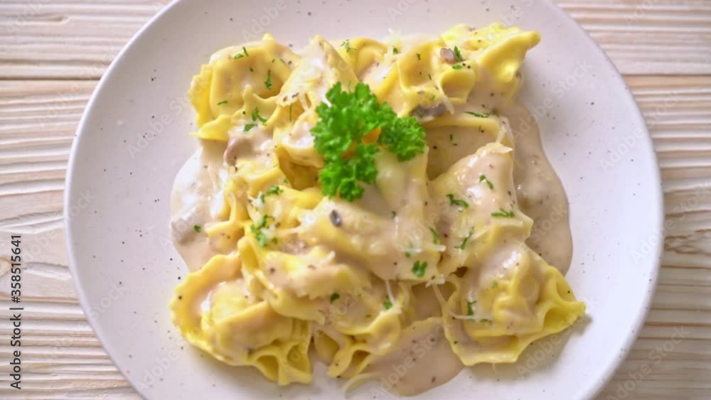 tortellini pasta with mushroom cream sauce and cheese - Italian food style tortellini pasta with mushroom cream sauce and cheese - Italian food style