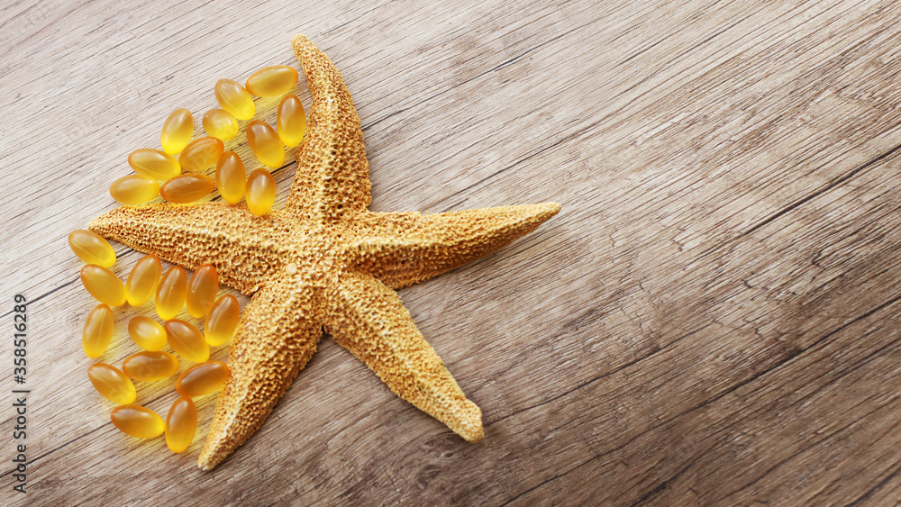 fish oil capsules on a wooden background fish oil capsules on a wooden background