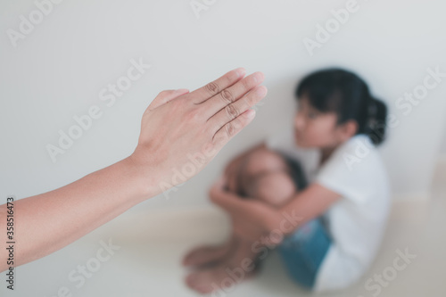 Asian young father beating his daughter by hand with concept
