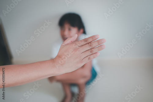 Asian young father beating his daughter by hand with concept

