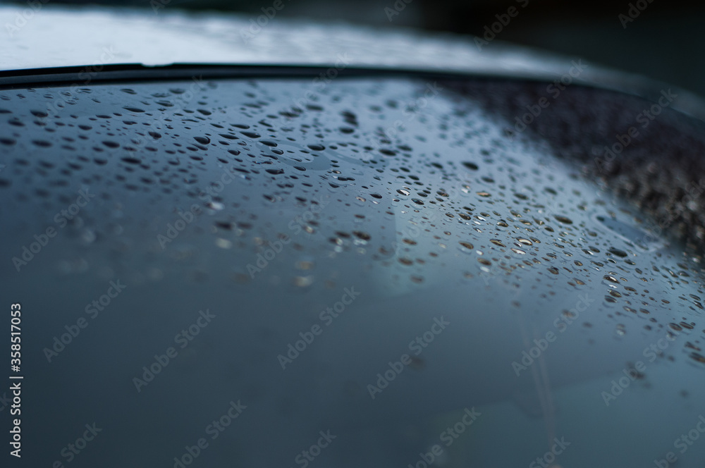 Water droplet on the car hood. Water beading after rain or car wash on