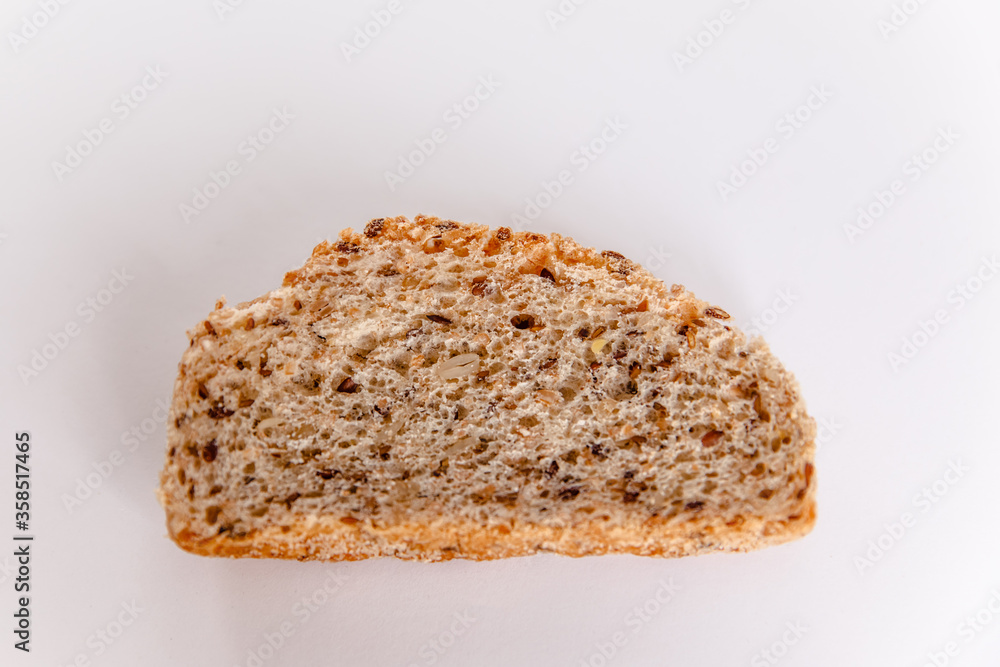 The piece of the French baguette isolated on a white background. The piece of the French baguette isolated on a white background.