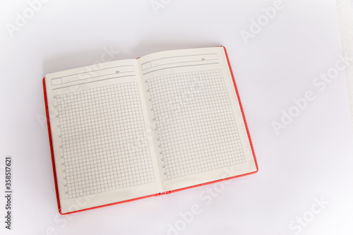 Open blank book, Copy space. Open red daily notebook book on white background
