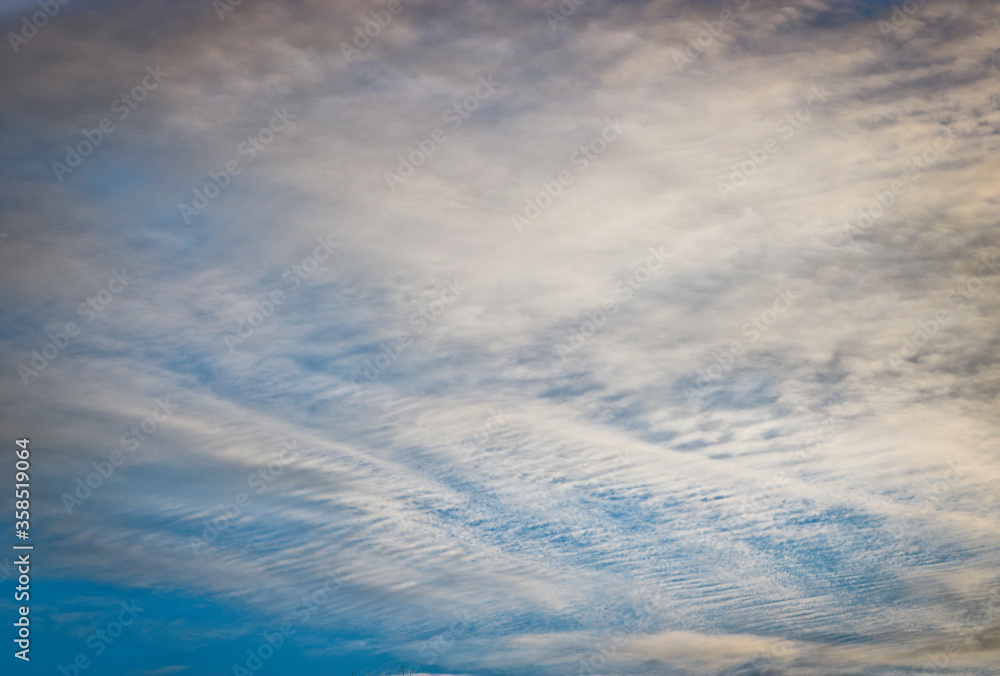 Evening sky with cirrus clouds. Natural background. The texture of the clouds.