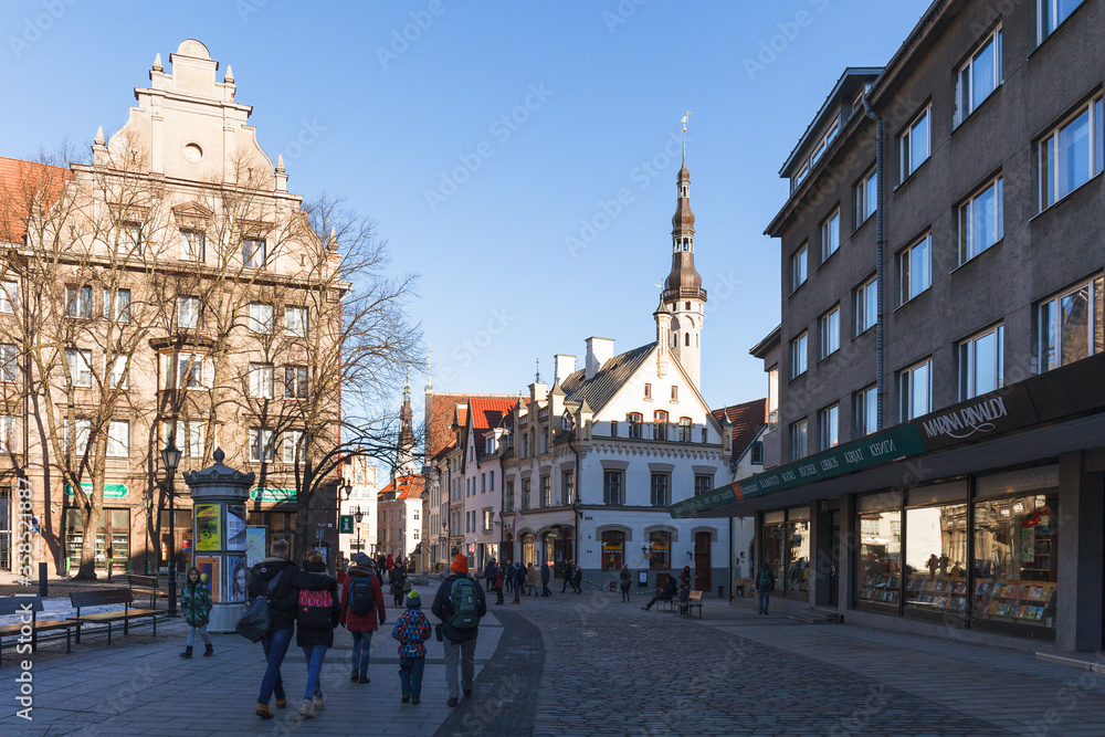 TALLINN, ESTONIA - DECEMBER 26, 2018: Tourists at street in old town. Sunny day.