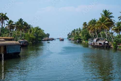 Valokuva Small houses in a local village located next to Kerala's backwater on a bright s
