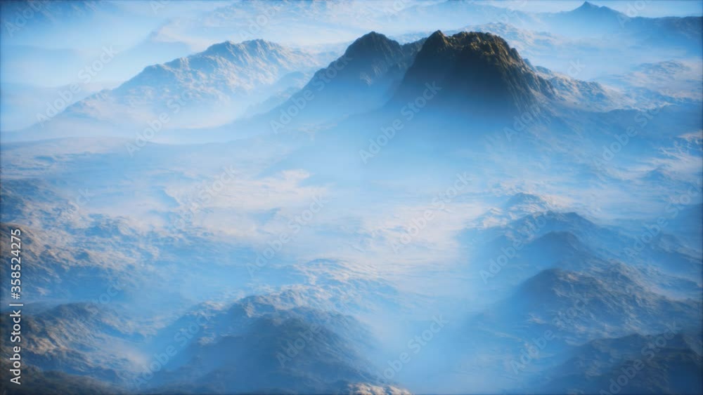 Distant mountain range and thin layer of fog on the valleys