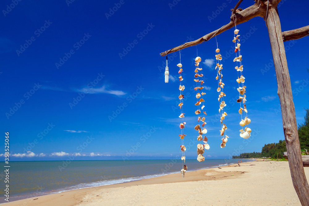 Sea shells hanging on strings at the beach of the Andaman Sea, Thailand Sea shells hanging on strings at the beach of the Andaman Sea, Thailand