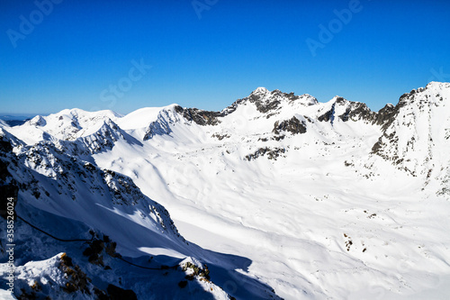 Winter trail mountain valley snow, High Tatra Mountains, Poland photo