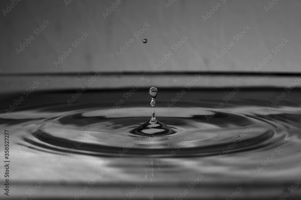 A small water drop fall on water surface A small water drop fall on water surface