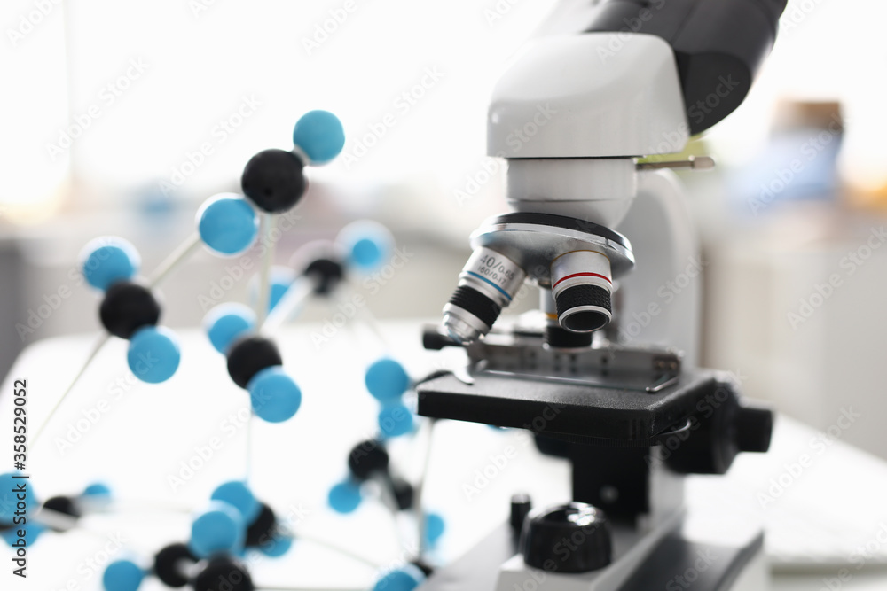 Close-up of modern device for laboratory investigation. Black and white equipment on working table. Tool to examine sample material. Light room. Lab and science concept Close-up of modern device for laboratory investigation. Black and white equipment on working table. Tool to examine sample material. Light room. Lab and science concept