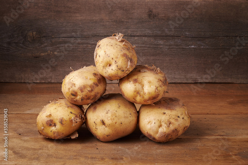 fresh potatoes on a wooden background