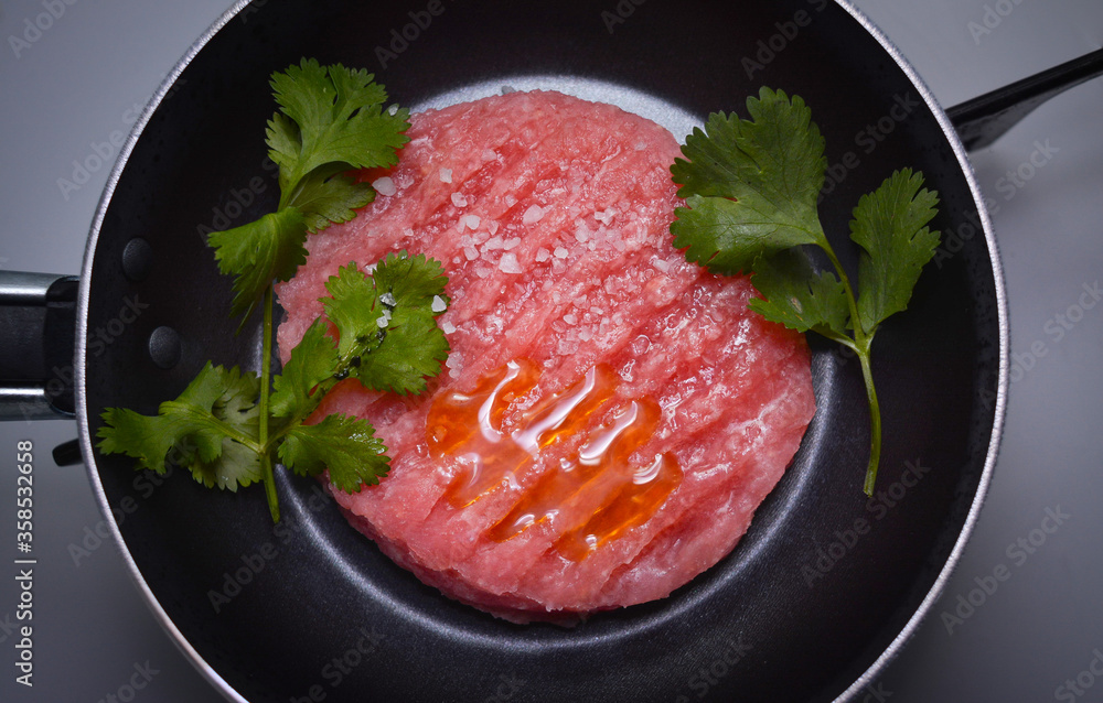 Raw minced meat burger before being cooked, food