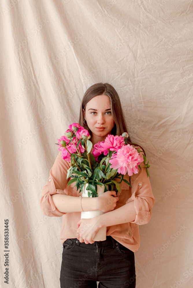 young woman with bouquet of peonies