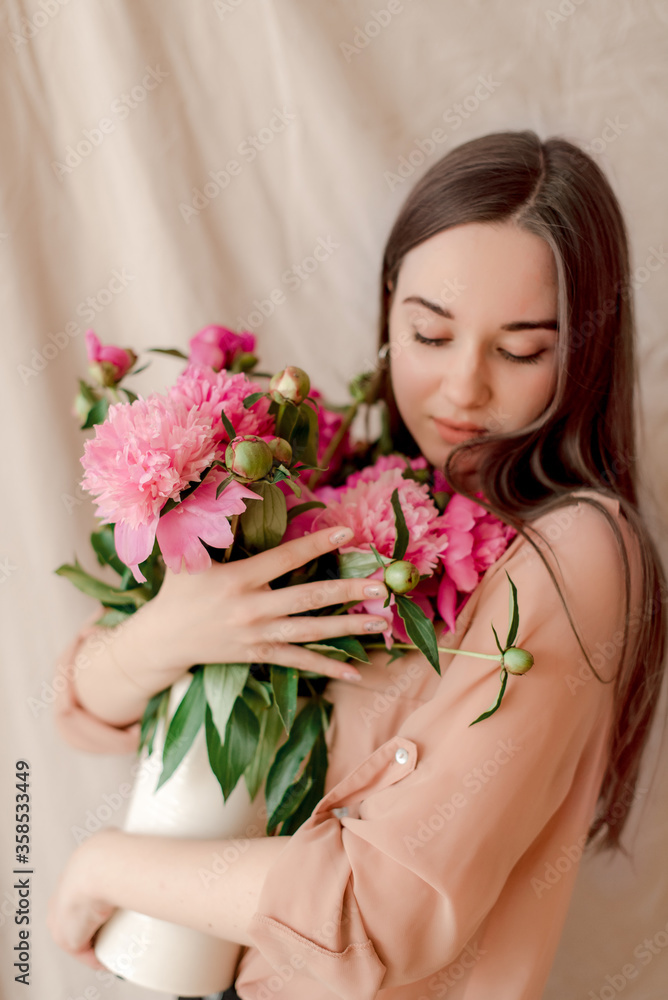 young woman with bouquet of peonies