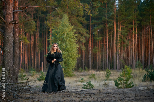 girl witch witch in a dark pine forest