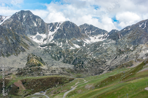 Sunny day with low clouds in the town of Pas de la Casa on the border between France and Andorra in June 2020. and Andorra in June 2020.