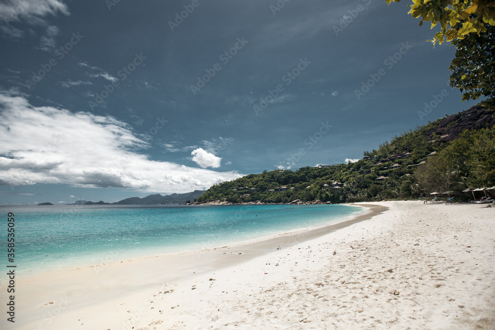 Beautiful seychelles island, ocean shore with white sand and blue sky