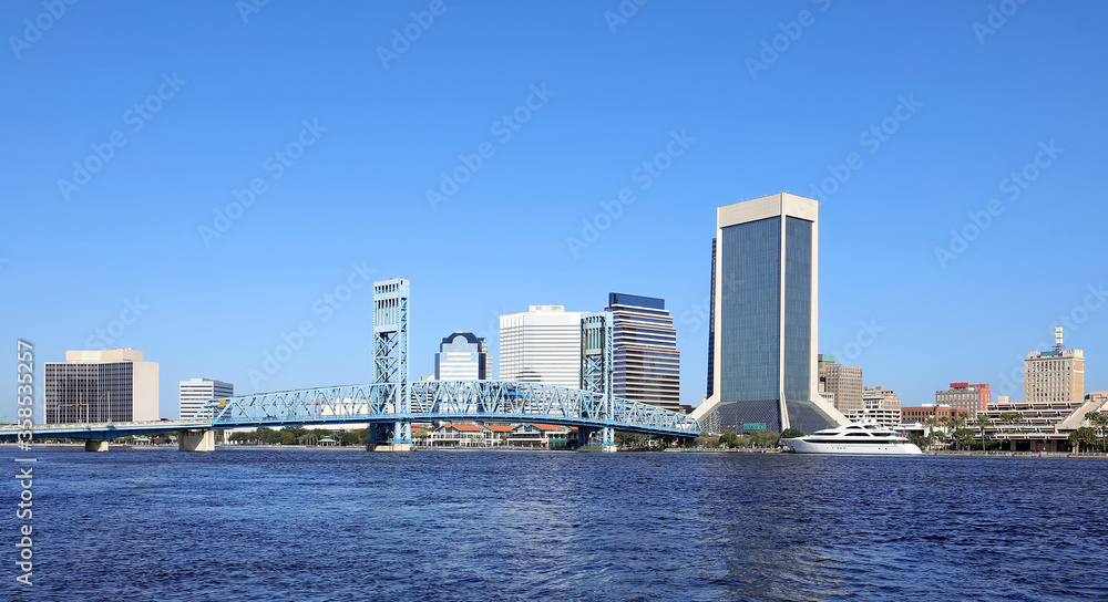 Clean and beautiful Jacksonville skyline as seen from Jacksonville Riverwalk on a clear blue sky day.