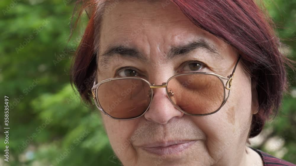 Face and eyes of a Caucasian old woman in glasses. Large wrinkles on the old woman's face. Face close up. portrait of an old woman with glasses Face and eyes of a Caucasian old woman in glasses. Large wrinkles on the old woman's face. Face close up. portrait of an old woman with glasses