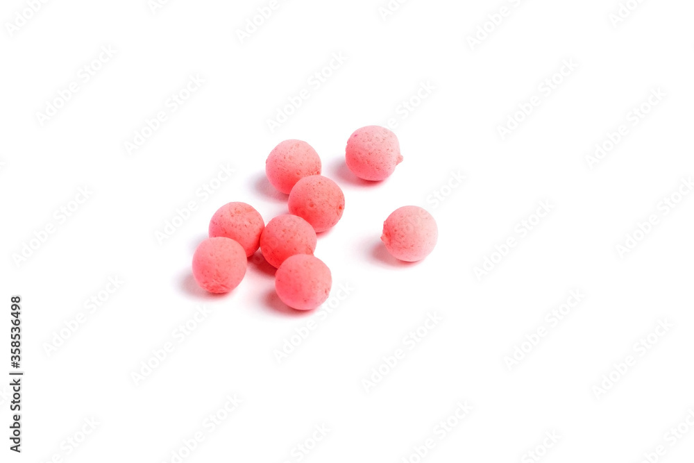 Close up view of orange boilies, fishing baits for carp isolated on white background.