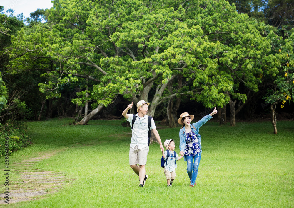 Fototapeta premium happy family hiking through the forest