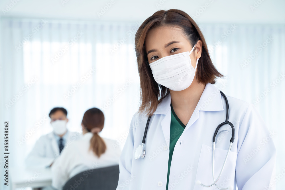 Asian female doctors wear surgical masks while working in hospitals