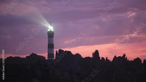 Creach lighthouse illuminated at dusk, the most powerful in the world, Ushant island, (aka Ouessant), Brittany, France