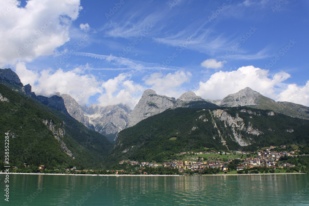 Green and blue landscape of Molveno lake with some clouds