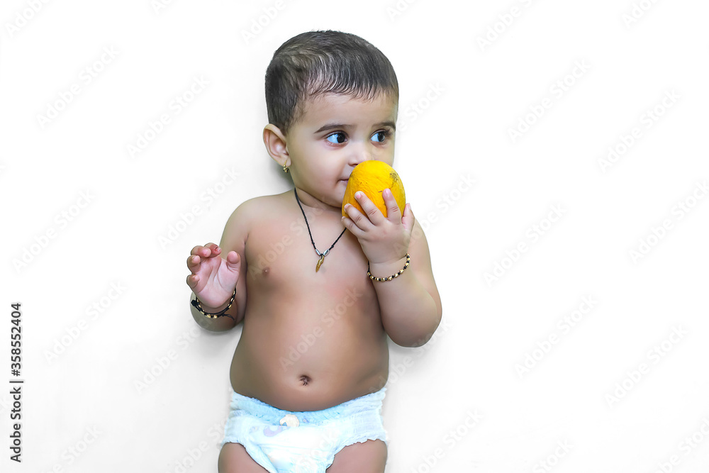 cute indian child eating mango