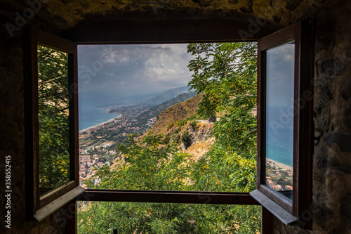  window overlooking the mediterranean sea in the city of FiumeFreddo  Calabria  Italy