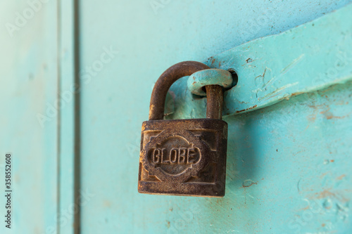 A large old metal lock hanging on a metal door on Muristan street in the old city of Jerusalem, Israel