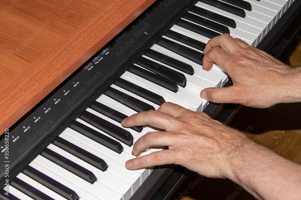 Fototapeta premium Two hands playing the piano
