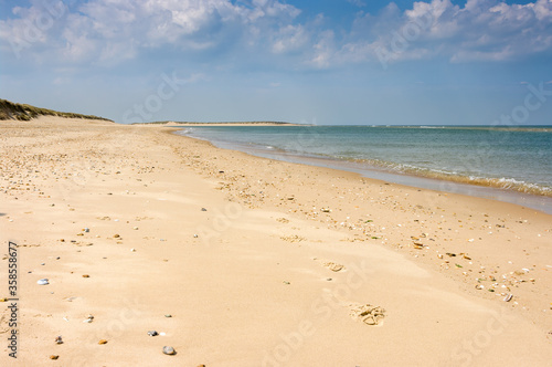 An empty sandy beach on a sunny spring day in the UK