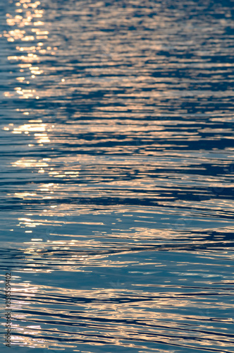 Sunset light reflecting on rippled water surface