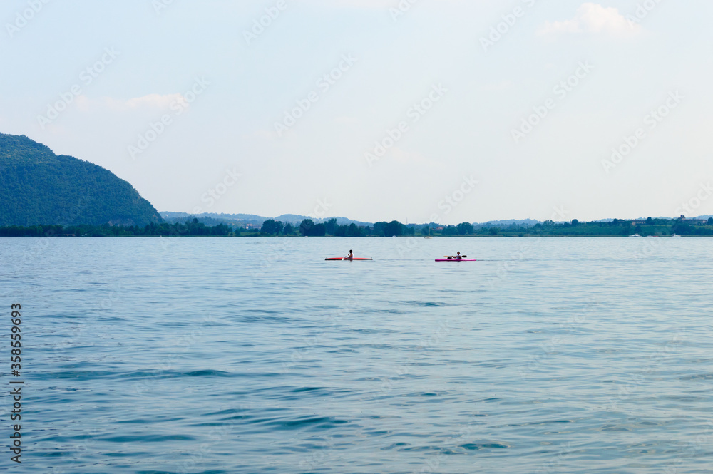 Two men canoeing on Lake Iseo in Italy