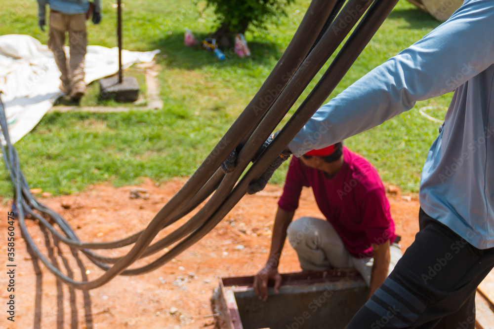 Workers are moving cables in construction sites. Workers are moving cables in construction sites.
