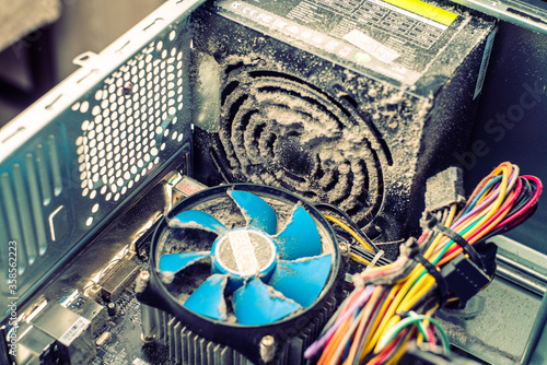 severe contamination of the computer system unit. computer inside. computer fan dust cleaner
