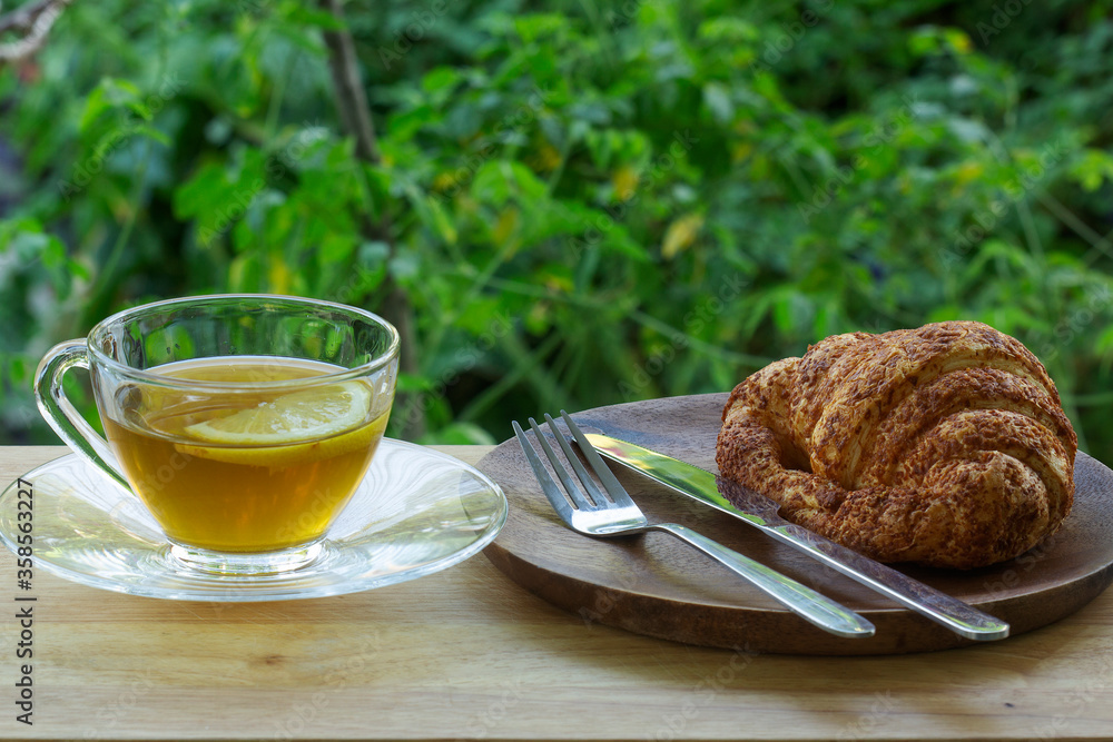Hot Tea with croissant bread on  Wooden Bar